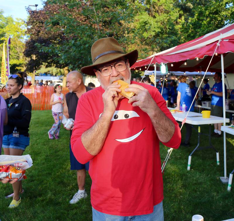 Terry McGinnis of Maple Park enjoys a hot dog at the Elburn Fireworks Show at Lions Park on Saturday, July 6, 2024 in Elburn.
