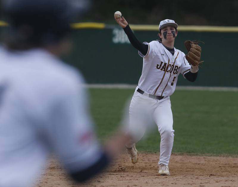Jacobs' Gage Martin throws to first base during a Fox Valley Conference baseball game against Cary-Grove on Wednesday, April 17, 2024, at Cary-Grove High School. The game was stopped for darkness after the 9th inning with the score tied 6-6.