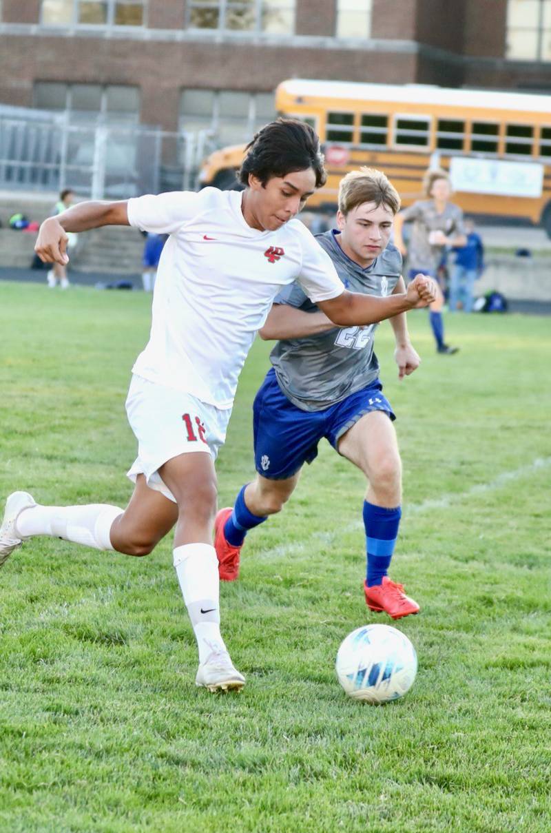 L-P's Jaiden Torres and Princeton's Izaiah Smallwood race for the ball Thursday at Bryant Field.