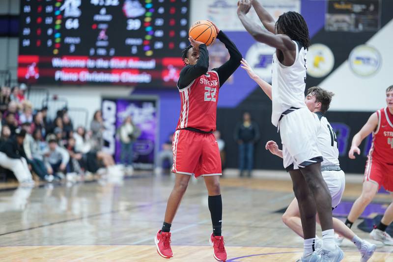 Streator's Tristan Finley (22) shoots the ball against Kaneland's Freddy Hassan (5) during a semi-final basketball game in the 61st annual Plano Christmas Classic at Plano High School on Friday, December 27, 2024.