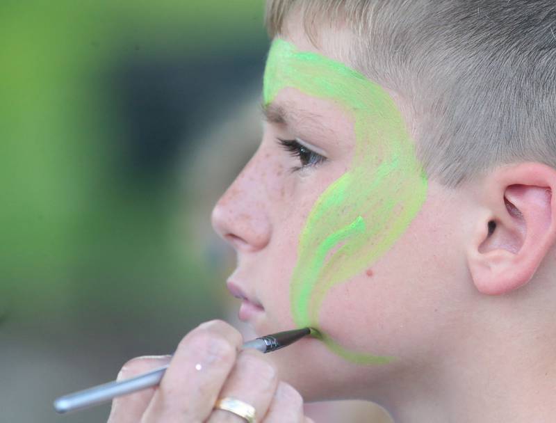 Chase Oliver gets his face painted National Night Out event on Tuesday, Aug. 1, 2023 at Zearing Park in Princeton.
