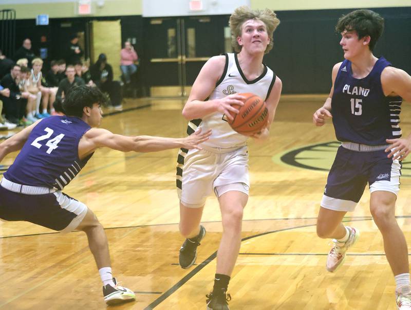 Sycamore's Lucas Winburn drives past a Plano defender Tuesday, Jan. 3, 2023, during their game at Sycamore High School.