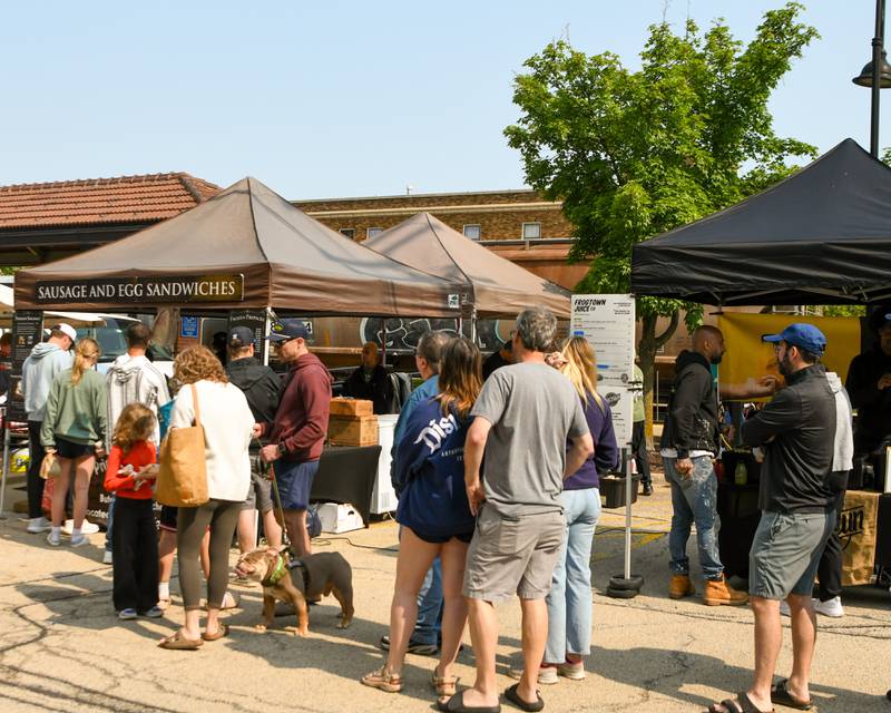 A line formed throughout the morning for a Sausage and egg sandwich on Saturday May 31, 2025, during the Farmers Market at the Main Street train station parking lot in Downers Grove.