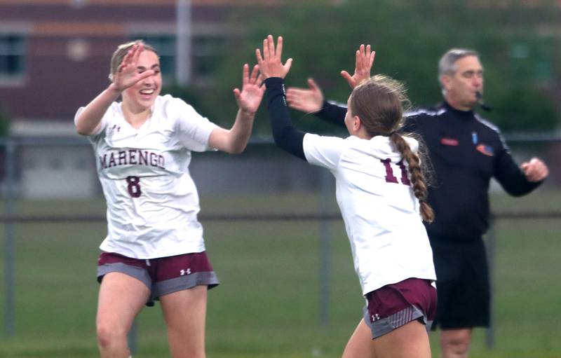 Marengo’s Kiley Brady, left, celebrates an OT goal by Mackenzie Westwood, right, against Richmond-Burton in IHSA Class 1A Regional Title Game action soccer at Marengo High School in Marengo on Wednesday, May 21, 2025.