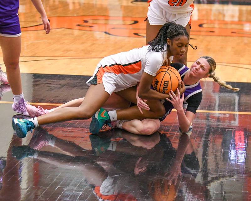 DeKalb's Brytasia Long, top, battles for the ball against Rochelle's Savanna Wilson during the game on Monday Dec. 2, 2024, held at DeKalb High School.