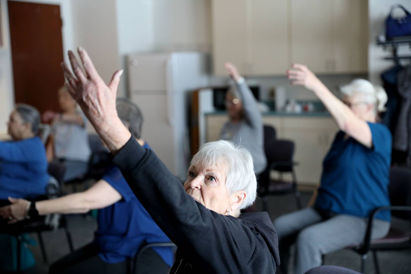 Diane Brown participates in a chair yoga class at the Town and Country Public Library in Elburn on Thursday, Jan. 25, 2024.