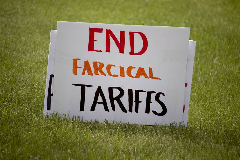 A sign critical of the tariffs imposed by U.S. President Trump on Thursday, May 1, 2025, in Joliet as part of a democracy rally. More than 20 people attended the rally held near the busy West Jefferson Street and the Joliet Regional Airport.