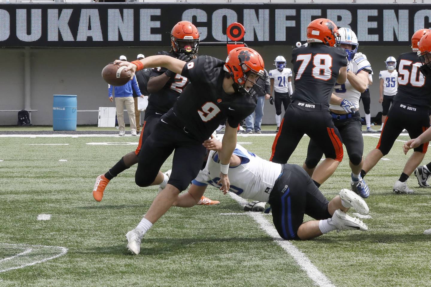 Wheaton Warrenville South quarterback Parker Brown scrambles with the ball Saturday, April 24, 2021 during their conference game at NIU against St. Charles North.