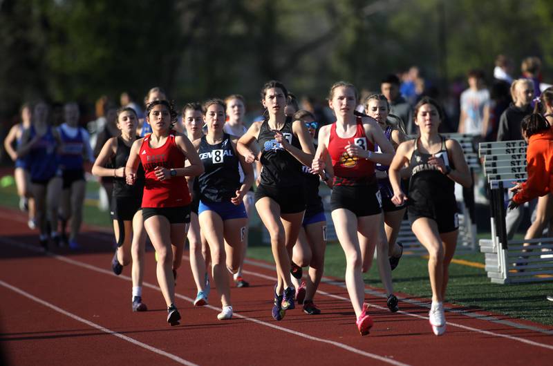 Runners compete in the 3200-meter run during the 2024 Kane County Girls Track and Field meet at St. Charles East on Thursday, April 25, 2024.