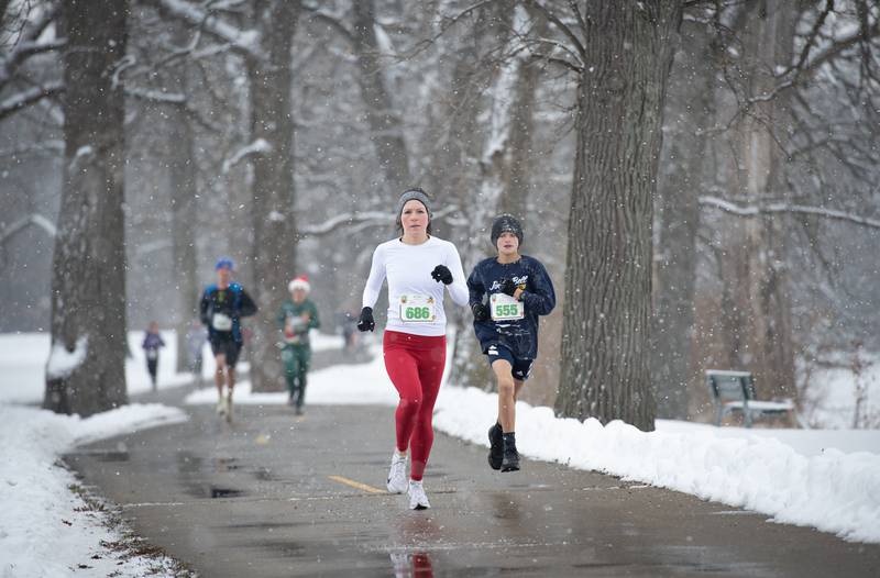 Runners in the 35th annual Jingle Bell Run run along the river at Kankakee Community College on Sunday, December 7, 2025.