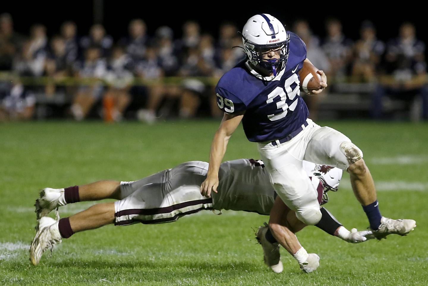 Cary-Grove's Holden Boone is tackled by Prairie Ridge's Dominic Creatore during a Fox Valley Conference football game on Friday, Sept. 22, 2023, at Cary-Grove High School in Cary.
