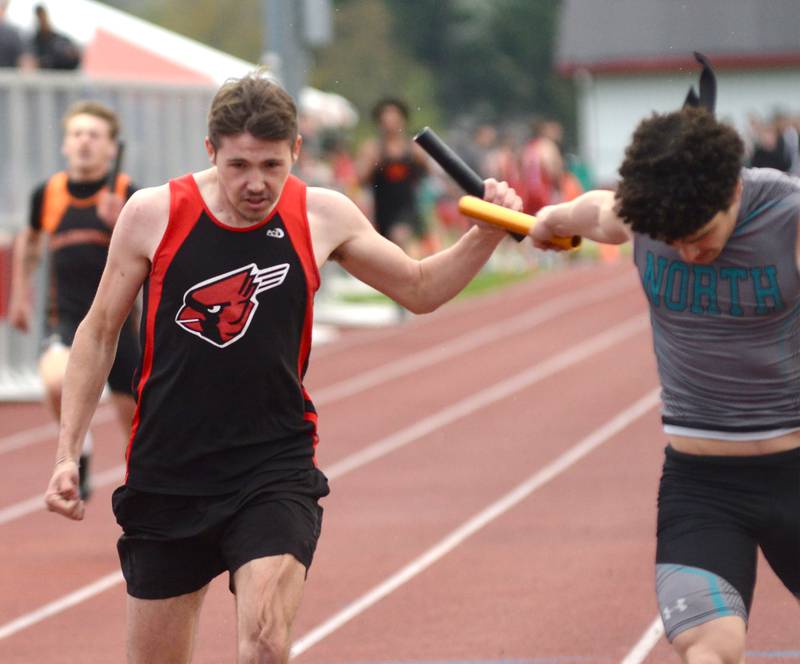 Forreston's Noah Dewey (left) chases Woodstock North's George Kingos (right) to the finish line in the 4x200 relay at the Hawk Classic on Friday, May 2, 2025 at Landers-Loomis Field in Oregon. Forreston finished second, 1:31.18 to Woodstock's 1:31.04.