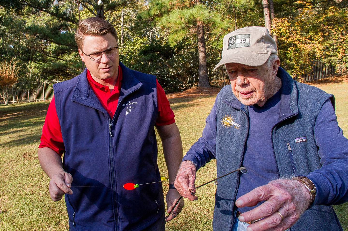 Voice of America correspondent Kane Farabaugh has former president Jimmy Carter show him fishing tips.