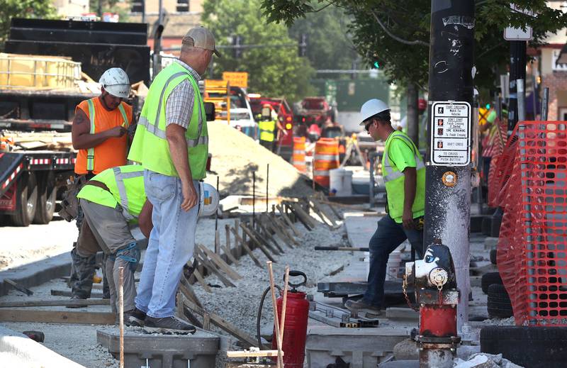Work continues on the sidewalk of Lincoln Highway near First Street Wednesday June 29, 2022, in DeKalb. Construction is ongoing on Lincoln Highway between First and Fourth Streets.