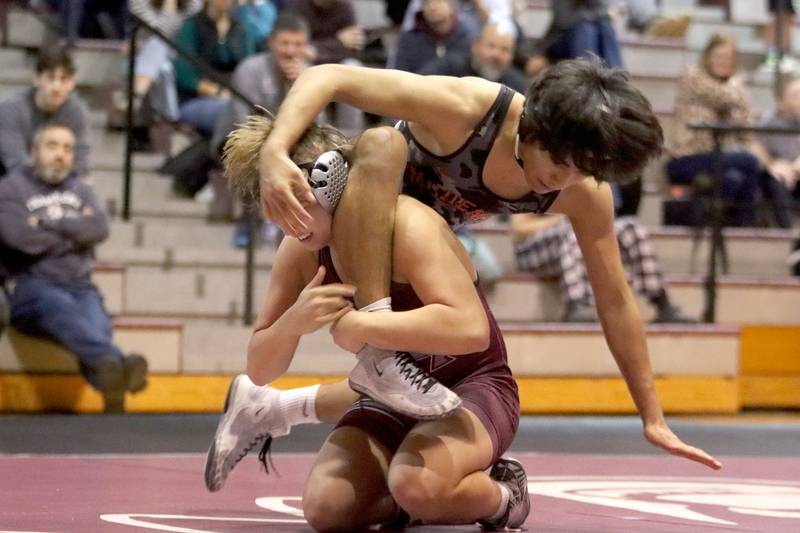 McHenry’s Elian Enciso is lifted by Prairie Ridge’s Jacob Meade at 165 pounds in varsity boys wrestling on Thursday, Jan. 8, 2026 at Prairie Ridge High School in Crystal Lake.