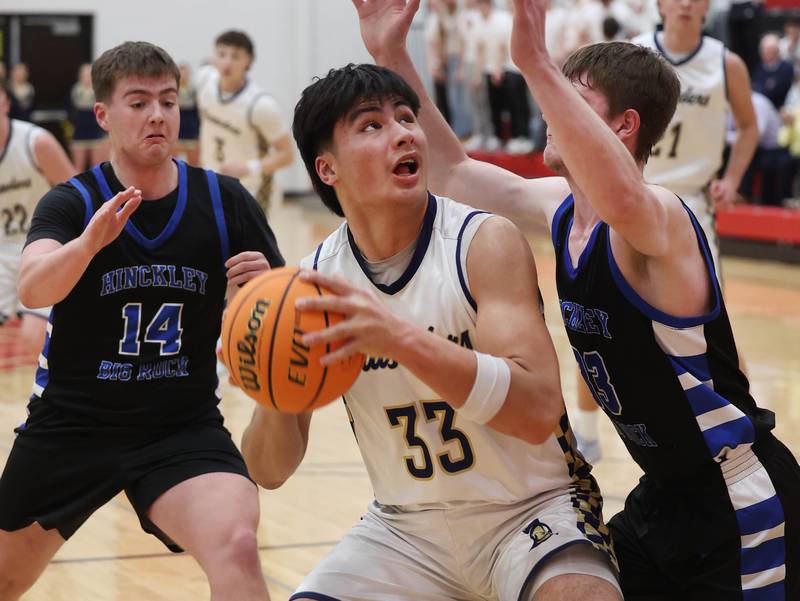 Marquette's Blayden Cassel  looks to shoot over Hinckley-Big Rock's Marshall Ledbetter Tuesday, March 3, 2026, during their sectional semifinal matchup at Amboy High School.