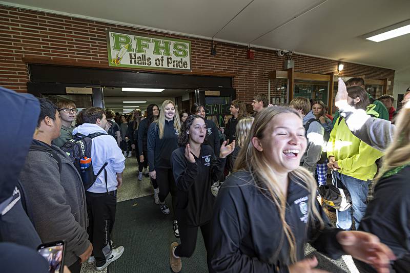 The Rock Falls volleyball team parades through the school hallway Thursday, Nov. 9, 2023 as they make their way to the bus that will take them to the state tournament.