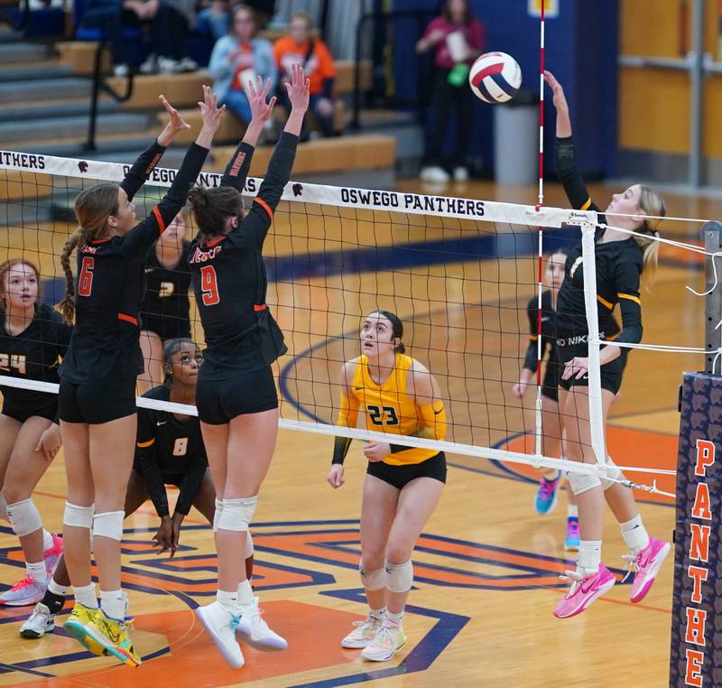 Joliet West's Ava Grevengoed (1) goes up for a kill against Lincoln-Way West's Lily Goyer (6) and Kara Stigter (9)during a class 4A Oswego Sectional semifinal match at Oswego High School on Monday, Oct. 30, 2023.