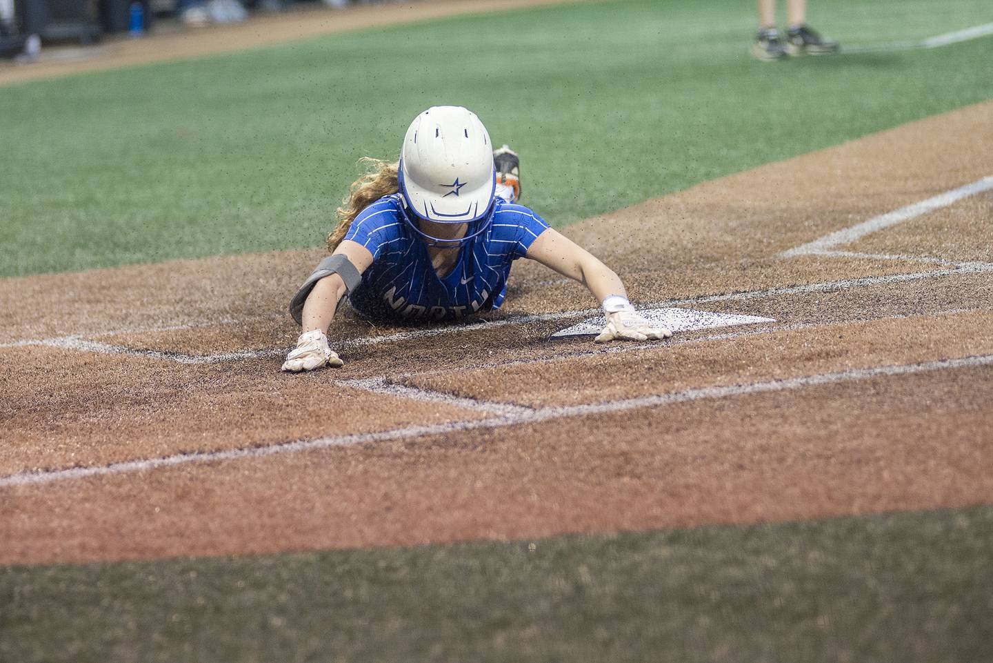 St Charles North’s Julia Larson comes in to score the second run against Edwardsville Friday, June 10, 2022 in the class 4A IHSA state softball semifinal game.