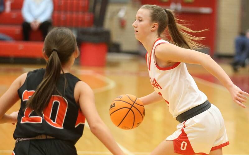 Ottawa's Ayla Dorsey runs the ball to to the top of the key while being guarded by Sandwich's Mia Geltz on Monday, Jan. 27, 2025 in Kingman Gym at Ottawa High School.