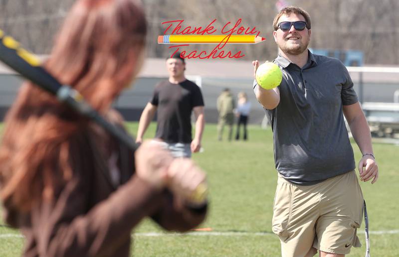 Griffin McNeal, Genoa-Kingston High School physical education teacher, pitches to students in his class Thursday, April 13, 2023, as they get outside to play some softball.