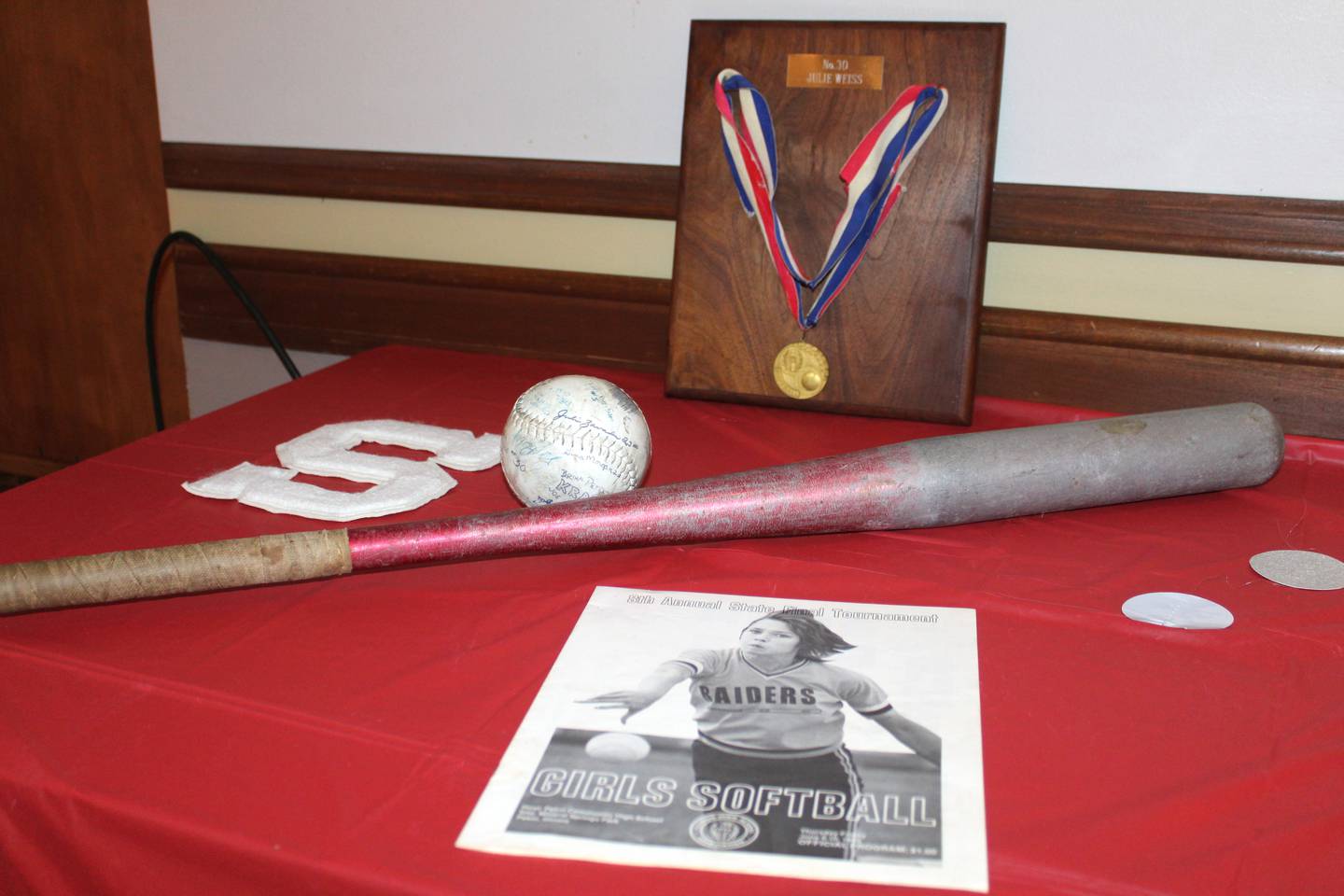 Julie (Weiss) Gabehart's state championship medal, a softball signed by the 1983 Streator softball team, a bat and the IHSA state tournament program were on display at the Night of Champions event Saturday, June 10, 2023, at the Streator PNA Hall marking the 40th anniversary of the team’s state championship.