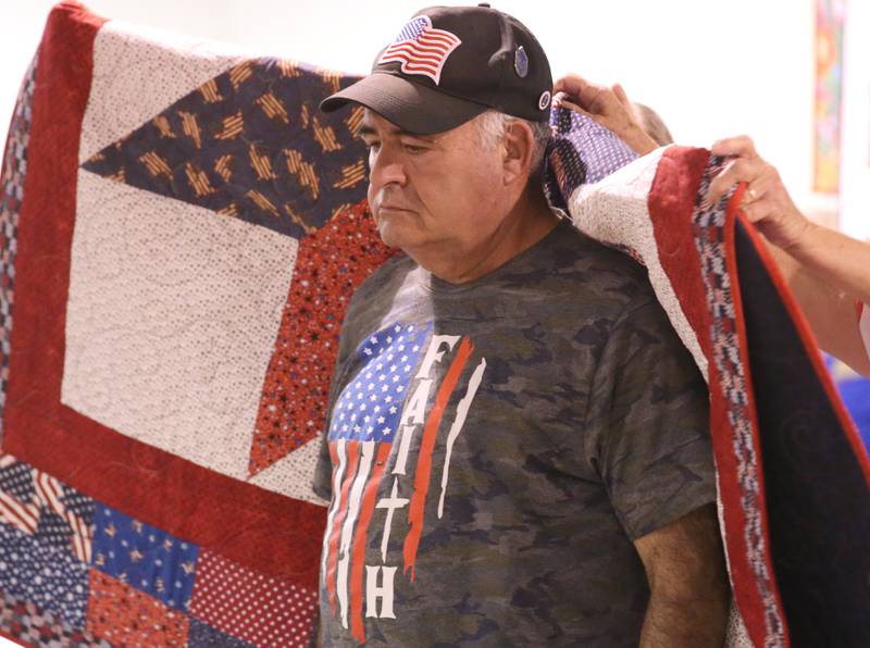 U.S. Air Force and National Guard Veteran Joseph Ruggerio of Huntertown Ind., receives his Quilt of Valor during the Tribute to Veterans on Wednesday, Aug. 20, 2025 at the Bureau County Fair in Princeton.