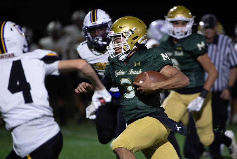 Bishop McNamara's Micah Lee carries the ball on a play in a game on Friday, September 19, 2025.