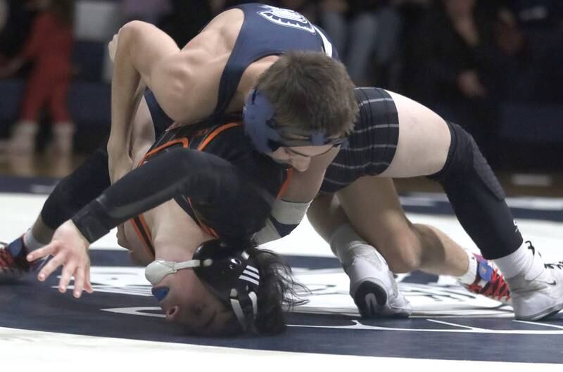 Crystal Lake Central’s Daniel Snow, bottom, battles Cary-Grove’s Levi Ardente at 132 pounds in varsity wrestling Thursday, Dec. 19, 2024 at Cary-Grove High School in Cary.