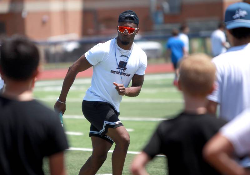 Former St. Charles North standout and current New York Giants defensive back Tyler Nubin works with young players on the first day of a three-day football camp on Friday, June 20, 2025 in St. Charles.