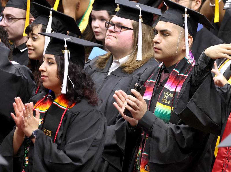Northern Illinois University candidates for graduation clap after moving their tassels from right to left during the first of two undergraduate commencement ceremonies Saturday, May 11, 2024, in the Convocation Center at NIU in DeKalb.