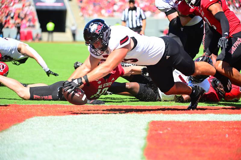 NIU fullback Brock Lampe recovers a fumble in the Huskies' game Saturday, Sept. 28, 2024 at North Carolina State.