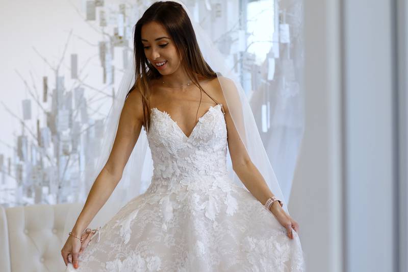 Bride-to-be Natalie Barclay tries on a new wedding gown for her mother, JoAnna Barclay, and bridesmaid Megan Colbert on Thursday, April 1, 2021, at Simply Luxe in Algonquin.