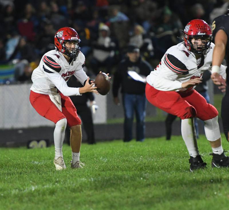 Fulton's Bryden Dykstra takes the snap against Lena-Winslow on Friday, Sept. 23 in Lena. He passed for 177 yards in the first half before Lena-Winslow took charge of the game in the third quarter.