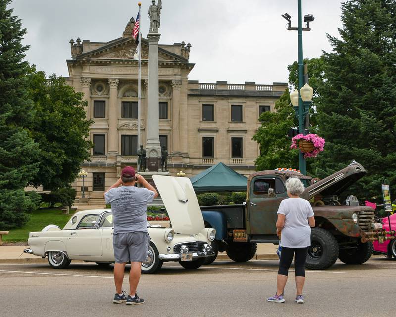 Greg Olson of Sycamore takes a picture of a 1956 Ford T-Bird sitting outside the DeKalb County Courthouse during the 24th annual Fizz Ehrler Memorial Turning Back Time Car Show held in downtown Sycamore on Sunday, July 28, 2024.