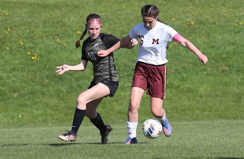 Morris' Abby Hanson tries to hold off Sycamore's Cortni Kruizenga during their Interstate 8 Conference Tournament semifinal game Wednesday, May 3, 2023, at Sycamore High School.