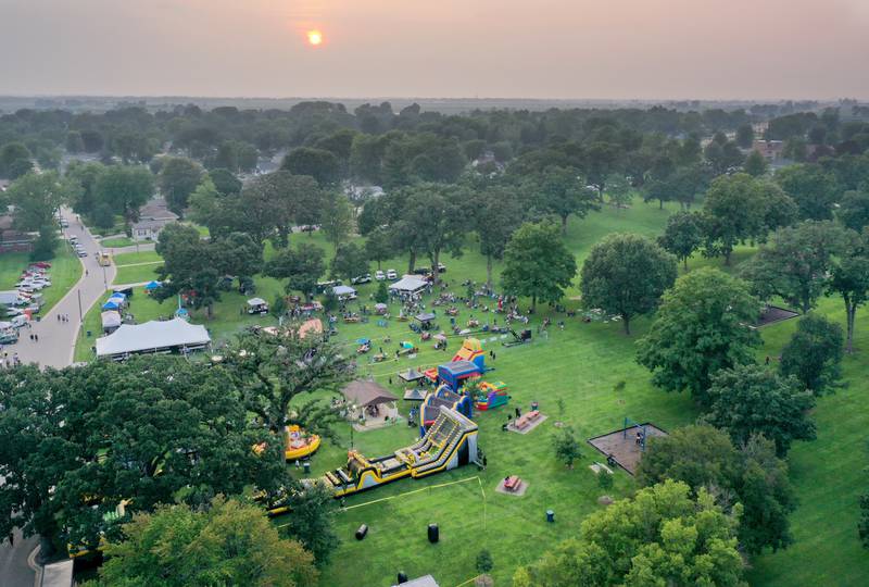 An aerial view of a hazy sunset over the The Taste of the Illinois Valley on Friday, Aug. 1, 2025 at Centennial Park in Peru. The haze is caused from the Canadian wildfires.