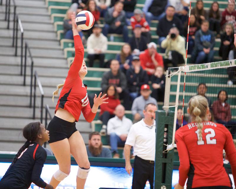 Benet's Ava Novak goes for the kill shot against New Trier at the Class 4A Super Sectional Final on Friday, Nov.3,2023 in Bartlett.
