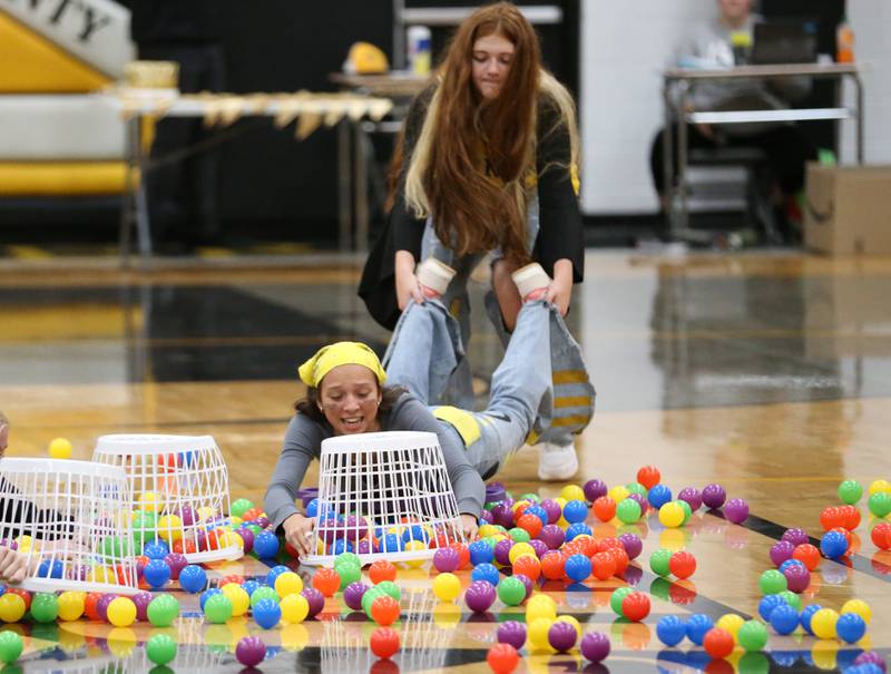 Eme Bouxsein collects balls in her basket with the help of Maggie Spratt while playing a game during the football Homecoming Pep Rally on Friday, Sept. 27, 2024 at Putnam County High School in Granville.