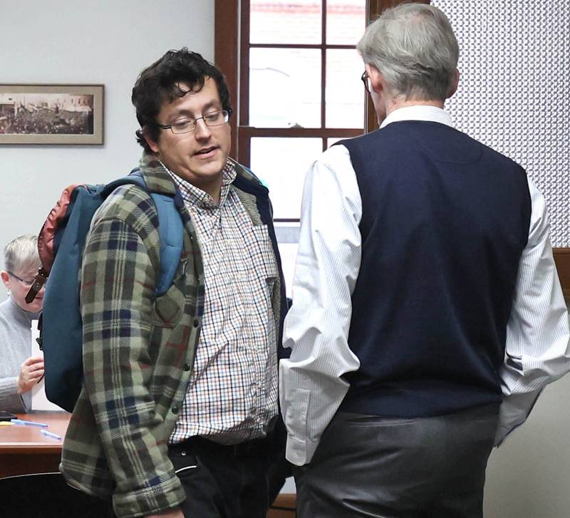 DeKalb City Clerk Sasha Cohen (left) walks past city manager Bill Nicklas Monday, Dec. 12, 2022, at City Hall, after Cohen was informed he would not be the person to accept candidate filings. Filing opened Monday at 8:30 a.m. and Ruth Scott, recording secretary to the DeKalb City Council, was on hand to accept the paperwork for candidates who were filing.