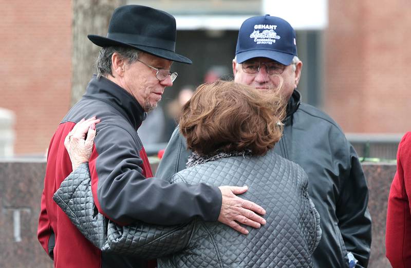Joe Dubowski, (left) father of shooting victim Gayle Dubowski, greets Charlotte Schiller and Larry Gehant, aunt and uncle of shooting victim Julianna Gehant, during a remembrance ceremony Tuesday, Feb. 14, 2023, at the memorial outside Cole Hall at Northern Illinois University for the victims of the mass shooting in 2008. Tuesday marked the 15th year since the deadly shooting took place on campus which took the lives of five people.