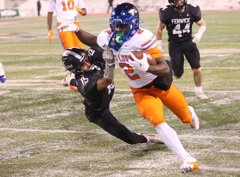 East St. Louis's Josh Morgan runs with the ball as Fenwick's Fran Madden brings him down during the Class 6A State championship game on Tuesday, Dec. 2, 2025 in Hancock Stadium at Illinois State University in Normal.