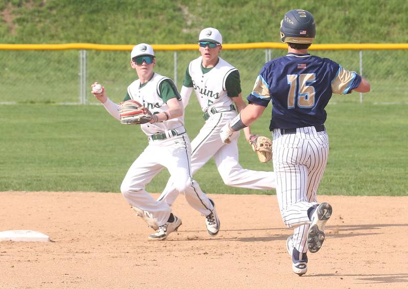St. Bede's Alec Tomsha looks to throw to first base as teammte Sturart McGunnigal backs him up while Marquette's Alec Novotney is forced out at second base on Thursday, April 24, 2025 at St. Bede Academy.