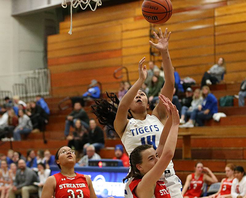 Princeton's Veronica Tirao (14) pulls up in the lane to score on a layup as Streator's Kora Lane (4) defends in the Lady Tigers Holiday Tournament on Tuesday, Nov. 15, 2022 in Princeton.