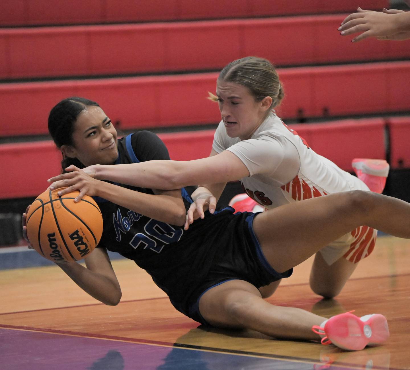 Maine South’s Phoebe O’Shea, right, keeps St. Charles North’s Sydney Johnson from passing the ball from the floor in a semifinal game of the Dundee-Crown holiday tournament in Carpentersville on Monday, Dec. 29, 2025.