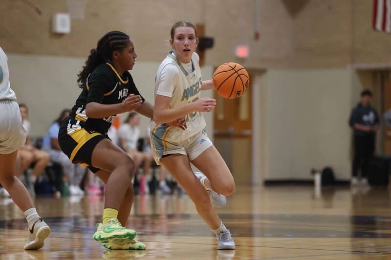 Joliet Catholic’s Abigail Dulinsky works the ball against Marian Catholic on Monday, Dec. 9, 2024 in Joliet.