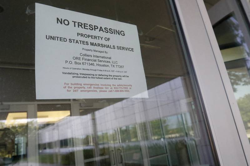 A sign reading "No Trespassing, Property of United States Marshals Service" hangs in the front doorway at the former Motorola headquarters on Thursday, June 10, 2021 in Harvard.