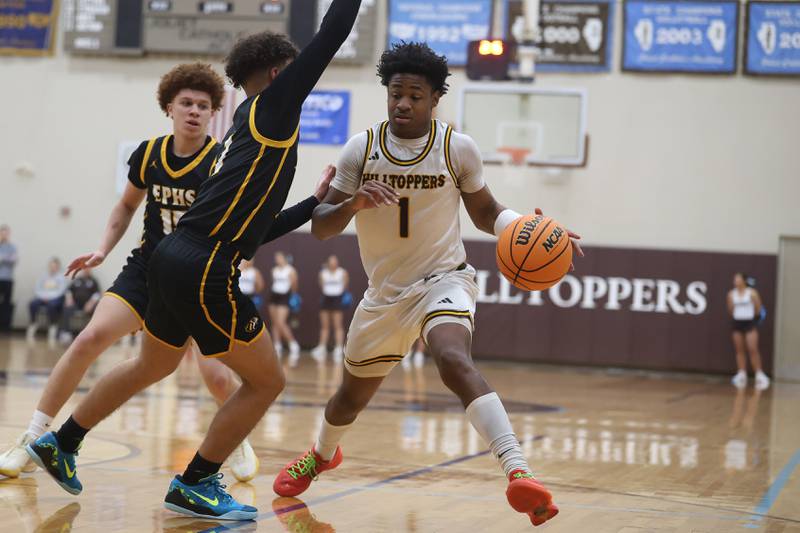 Joliet Catholic’s Jayden Armstrong makes a move against Elmwood Park in the Class 3A Joliet Catholic Regional semifinal game on Wednesday, Feb. 25, 2026 in Joliet.