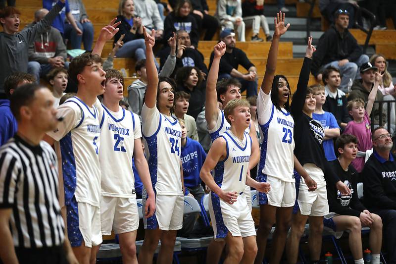 Woodstock players celebrate a teammates basket in the final minute of Woodstock victory over Woodstock North in Kishwaukee River Conference boys basketball game on Wednesday, February. 18, 2026, at Woodstock High School.