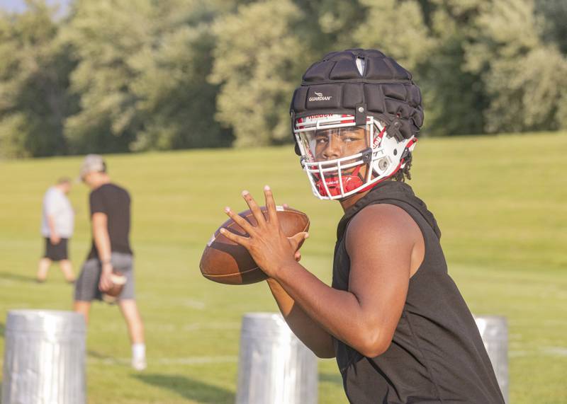 Ottawa quarterback Colby Mortenson looks downfield during the Pirates' first official practice of the season Aug. 7, 2023.